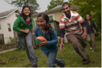 family playing outside with ball