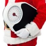 santa holding a scale