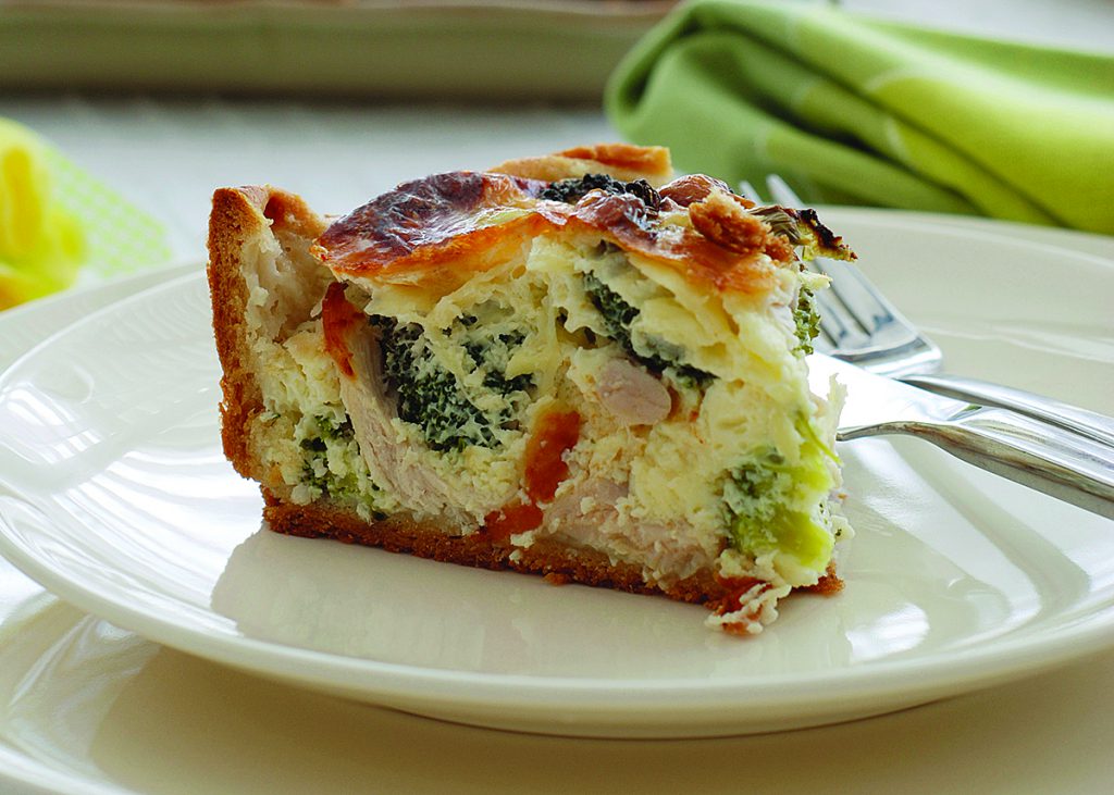 quiche cut on plate with fork 