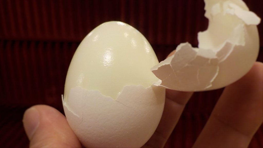 half peeled hard boiled egg