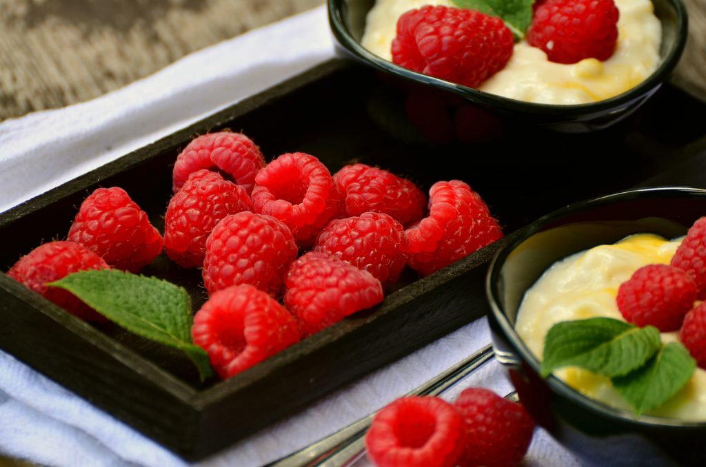 raspberries ontpop of pudding cups 