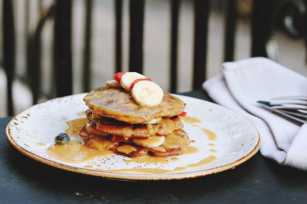 plate of pancakes with fruit on top