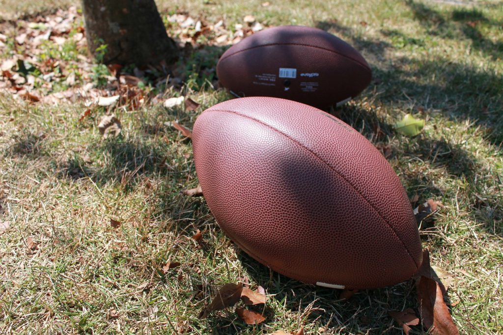 two footballs outside 