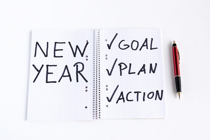 New Year - Goal, Plan, Action written on notebook page