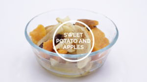 A clear bowl with a serving of baked sweet potato and apple slices.